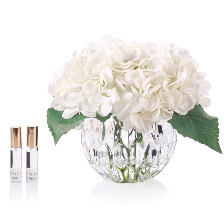 Perfumed bouquet of hydrangeas in transparent vase White